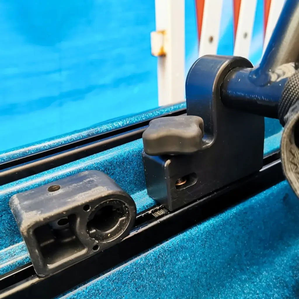 Front seat riser bolted onto the deck rail of a teal speckled Native Slayer kayak