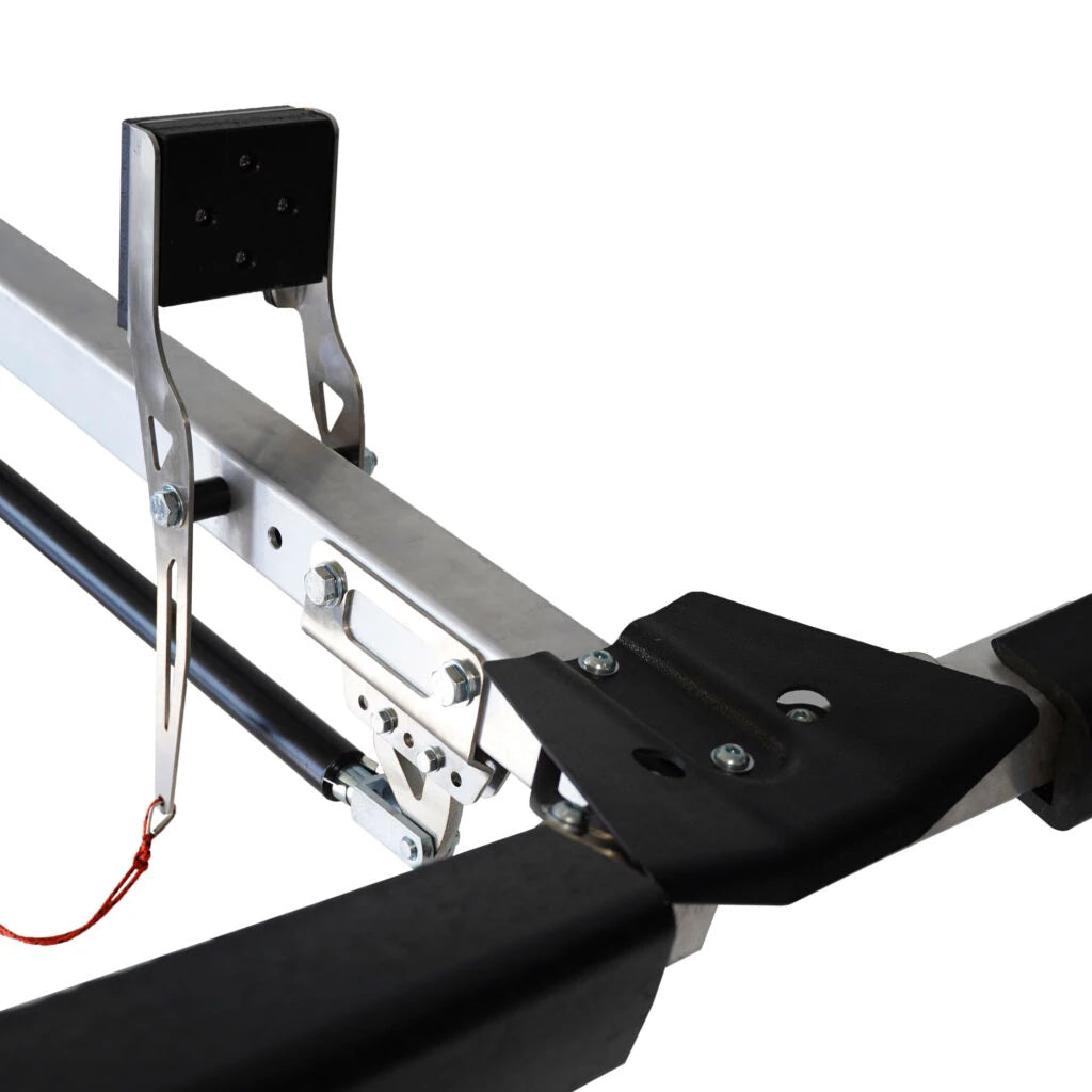 Close-up of the Will-I kayak loader arm, black cradle pad and red release cord on a roof rack