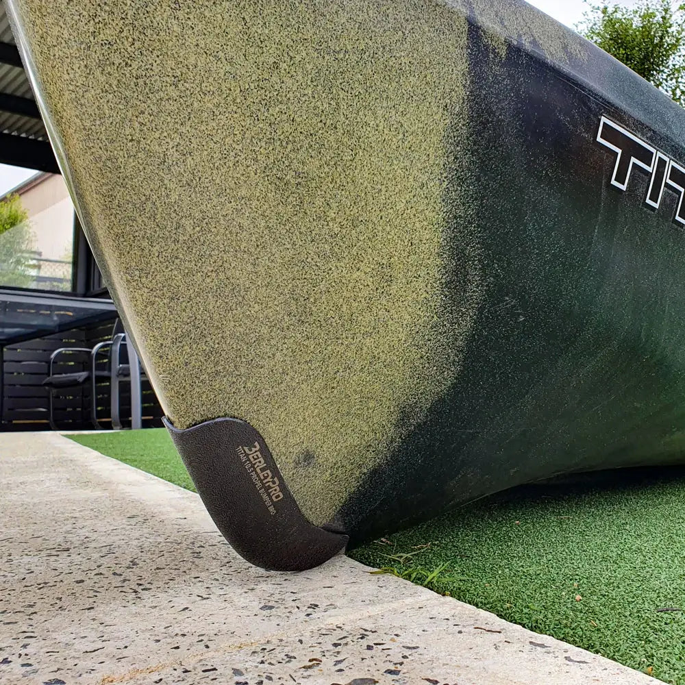 Bumper Bro fitted to the bow of an olive camo Native Titan 10.5 resting on concrete