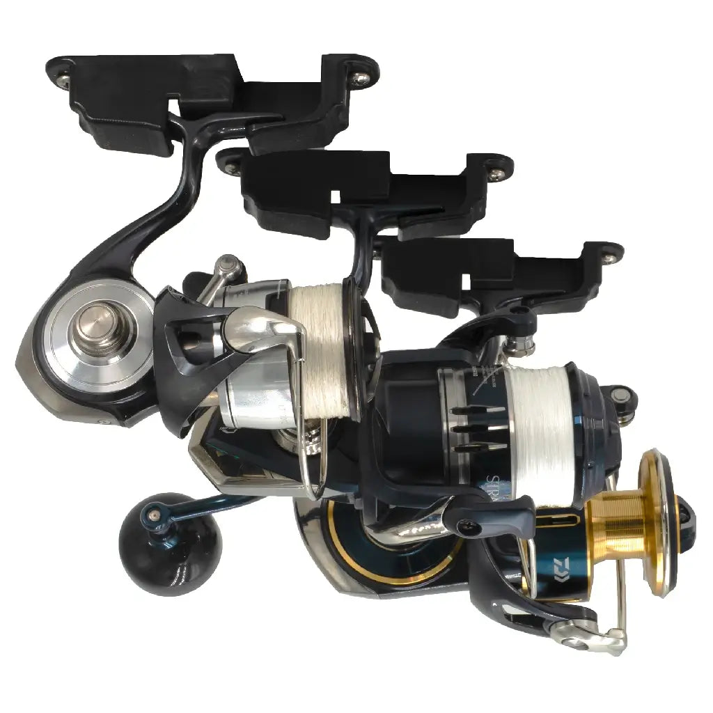 Several spinning reels hanging by their feet from black Reel Docks on a white backdrop