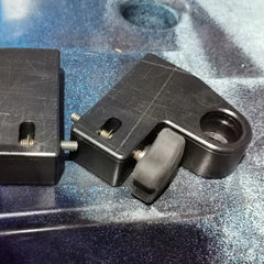 Close-up of a front seat riser block bolted to the rail of a blue Native Slayer kayak deck