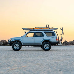 4WD on a salt flat with a Hobie Lynx on the roof and the kayak loader arm extended