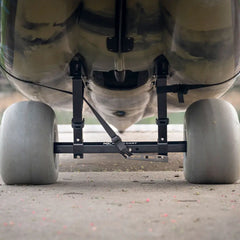 Kimmi Cart kayak trolley with balloon sand wheels supporting a heavy kayak hull, viewed from the rear