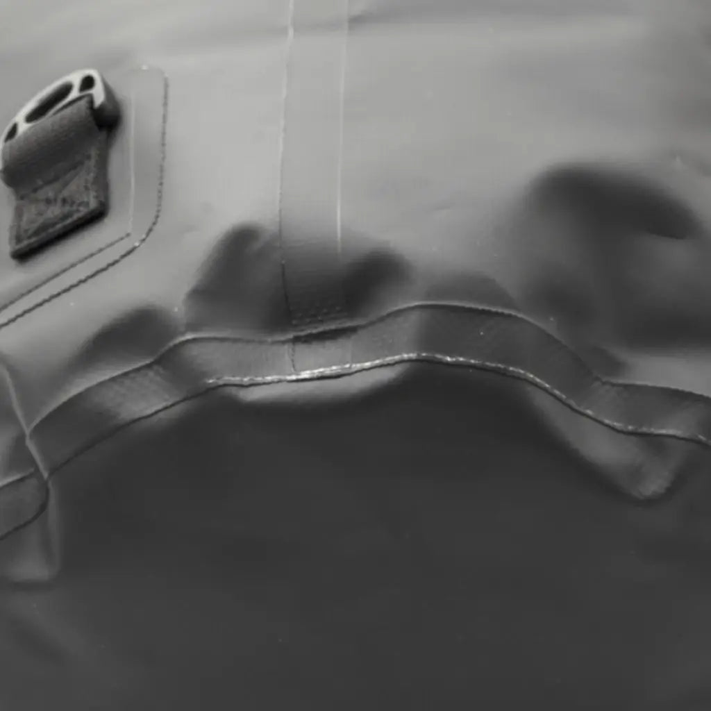 Extreme close-up of the welded seam and base construction of the black dry bag