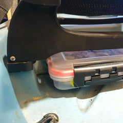 Compass seat risers lifting the seat on a teal Hobie deck with a tackle box stowed beneath