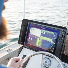 Simrad sounder showing depth traces at a boat helm on open water